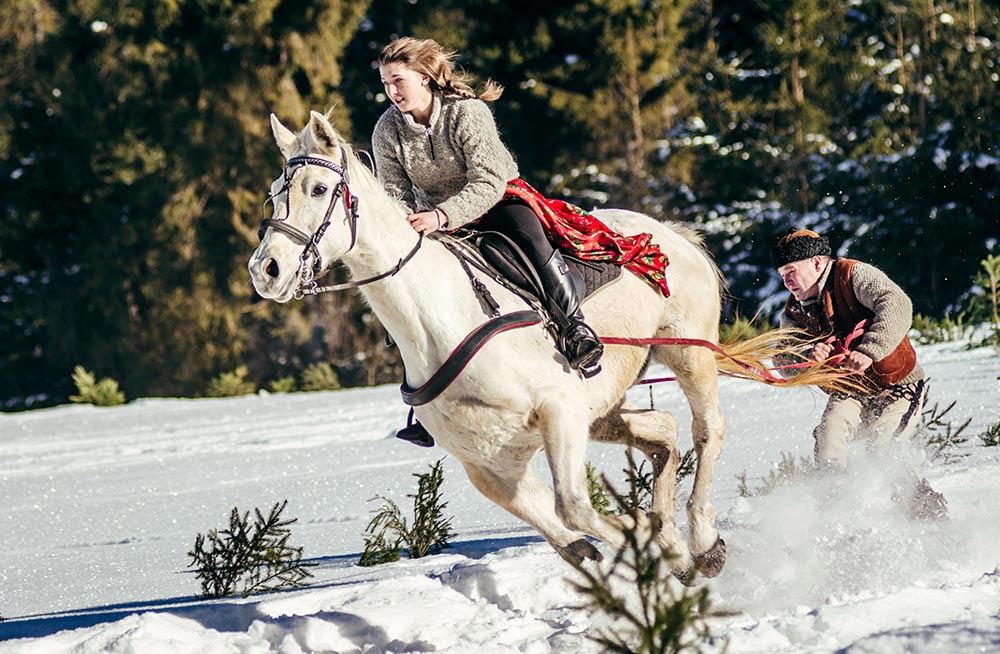 Locals competing in horse-drawn skiing (Photo by Lukasz Nodzynski/ AFP)